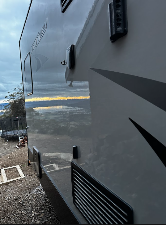 After — Grey Jayco Journey caravan panel before and after a machine polish